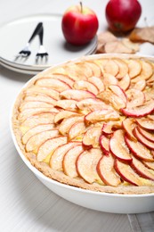 Photo of Tasty apple pie on white wooden table, closeup