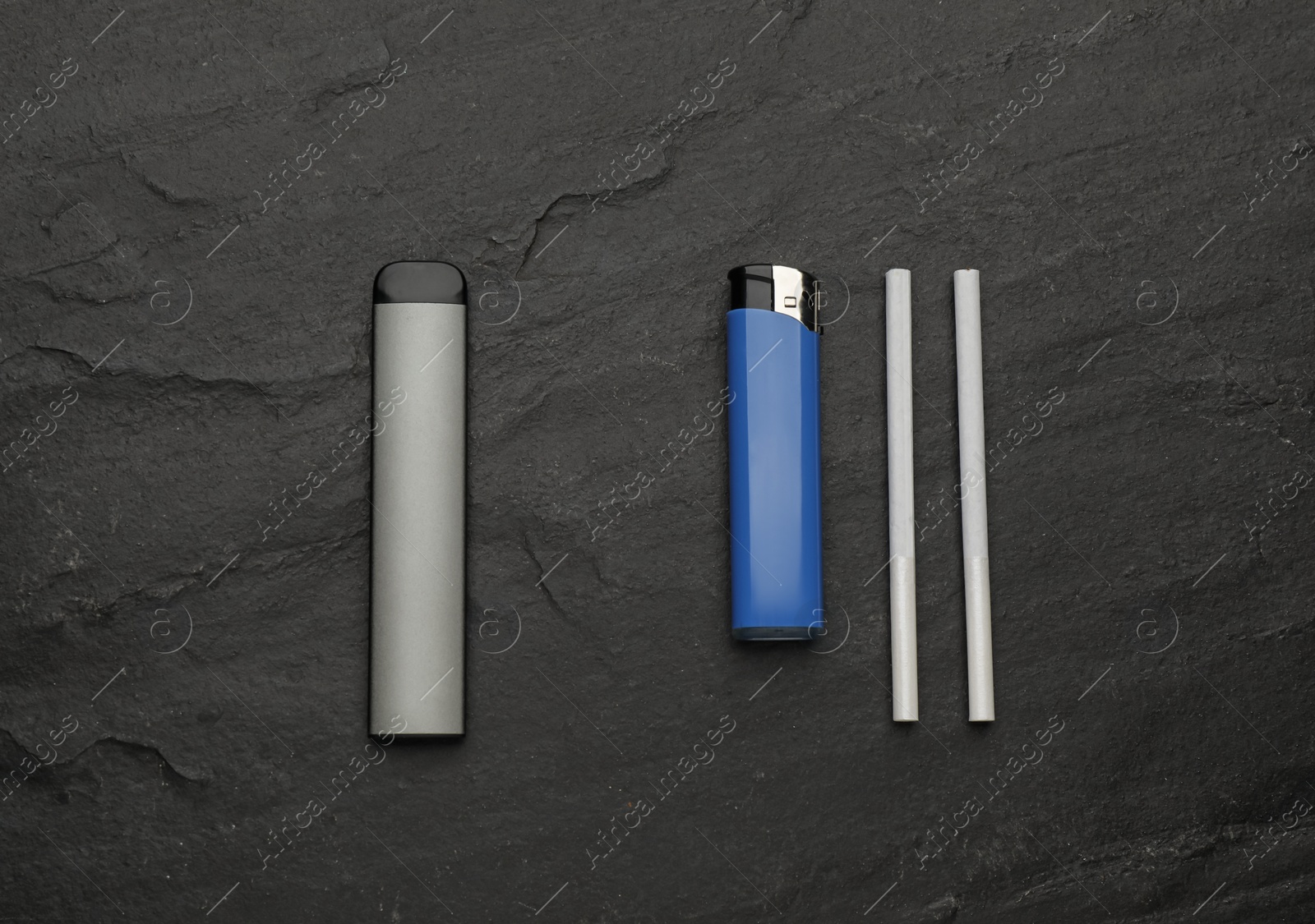 Photo of Disposable electronic smoking device near lighter and cigarettes on black background, flat lay