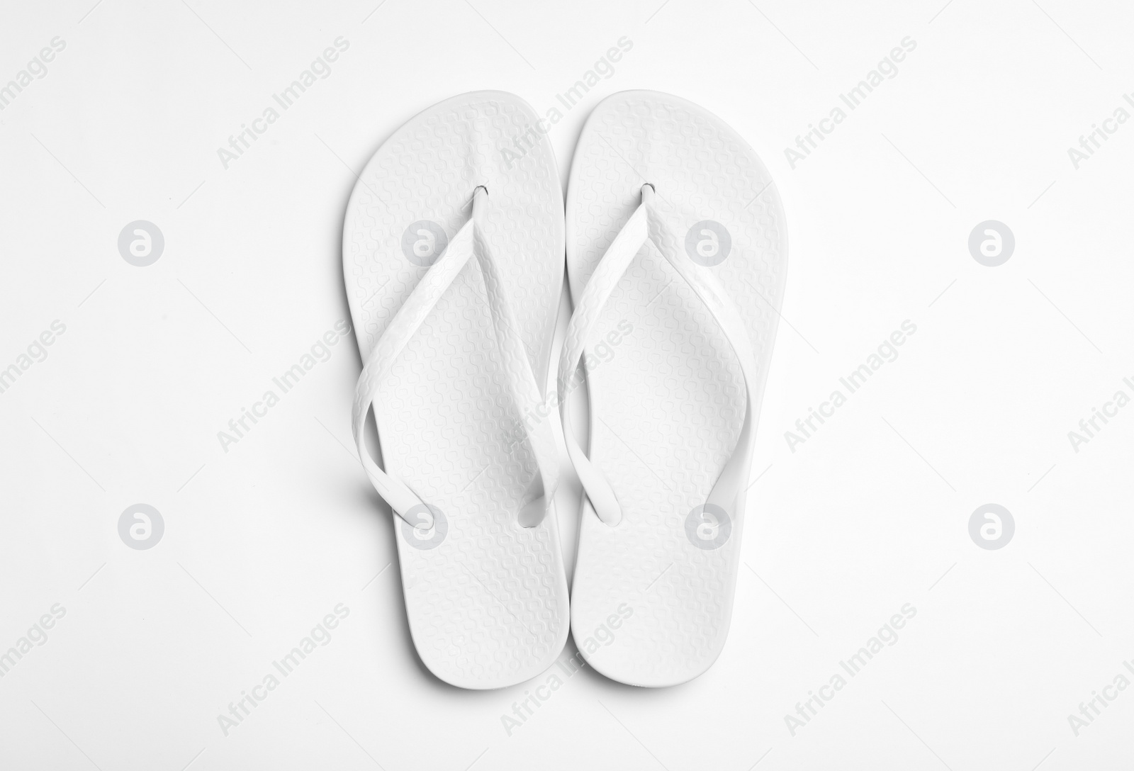 Photo of Pair of flip flops on white background, top view. Beach accessories