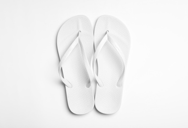 Photo of Pair of flip flops on white background, top view. Beach accessories