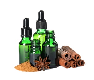 Photo of Bottles of essential oils, cinnamon sticks and powder on white background