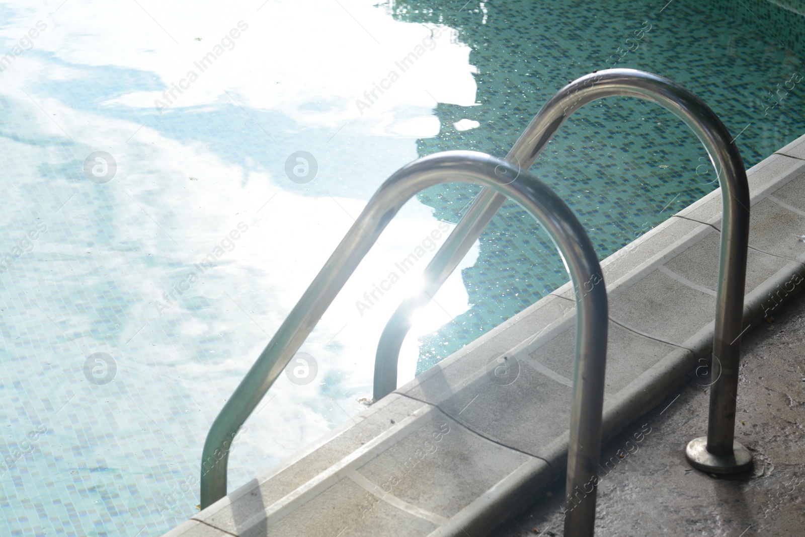 Photo of Ladder with grab bars in outdoor swimming pool