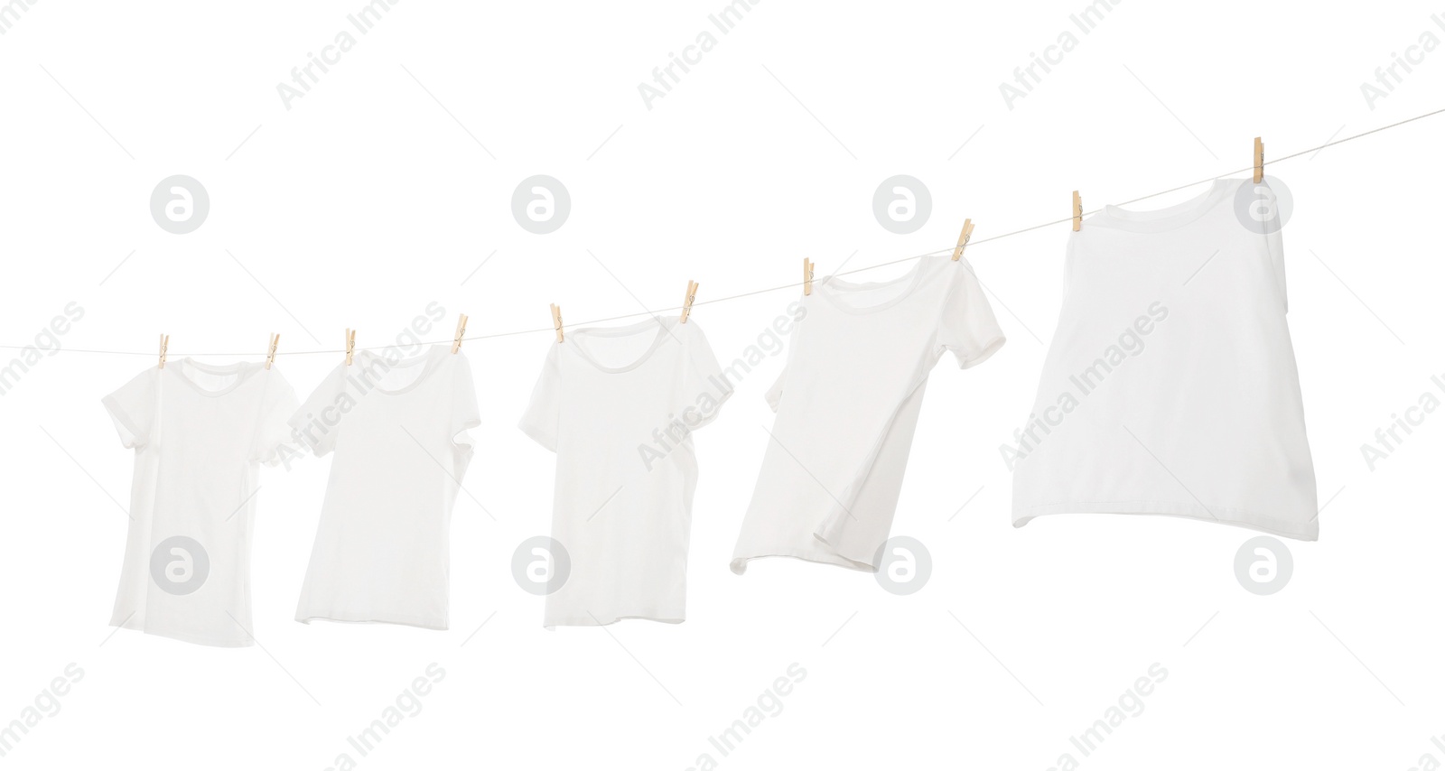 Photo of Many t-shirts drying on washing line isolated on white