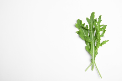 Photo of Fresh arugula on white background, flat lay. Space for text