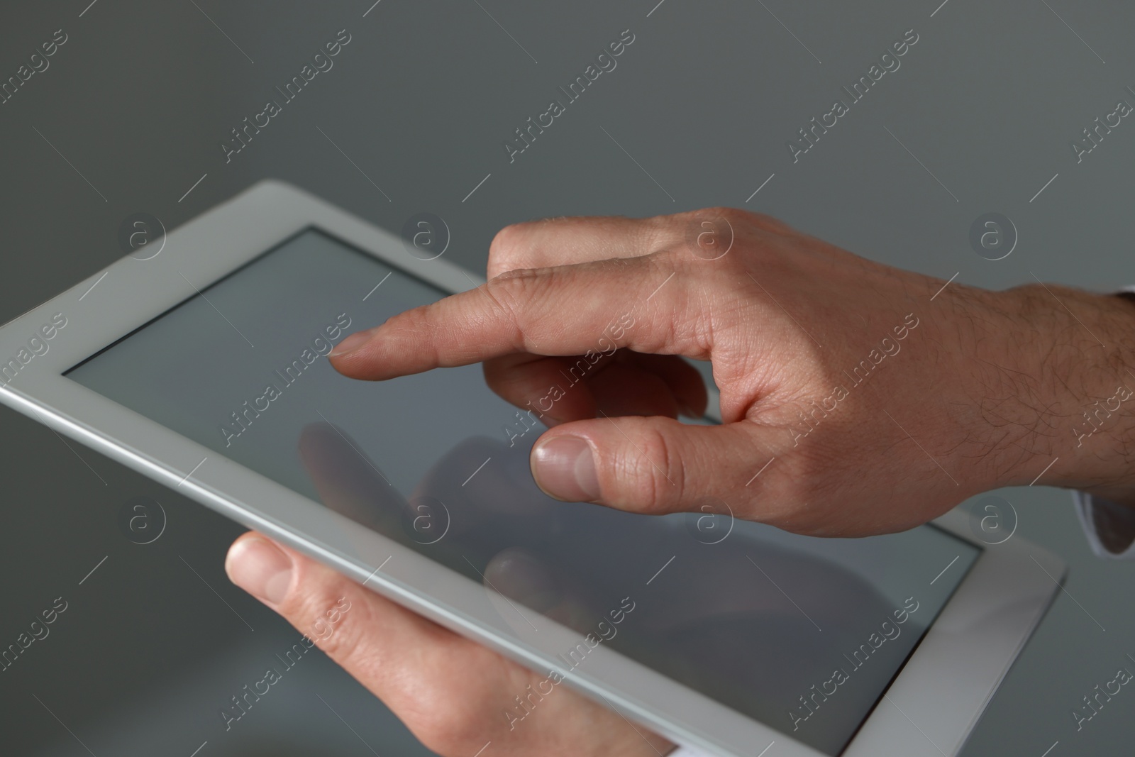 Photo of Closeup view of man using new tablet indoors