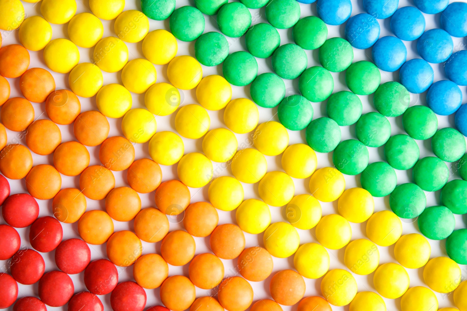 Photo of Many colorful candies as background, top view