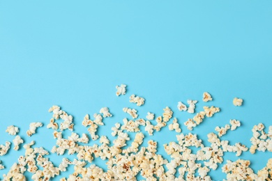 Flat lay composition with tasty popcorn and space for text on color background