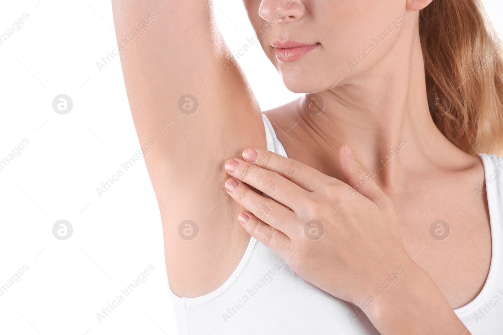 Photo of Young woman showing armpit on white background, closeup. Using deodorant