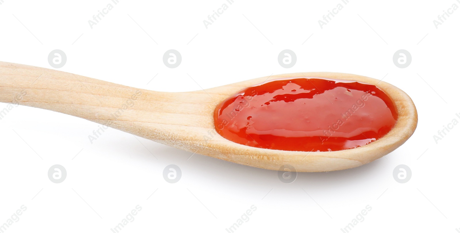 Photo of Spicy chili sauce in spoon isolated on white