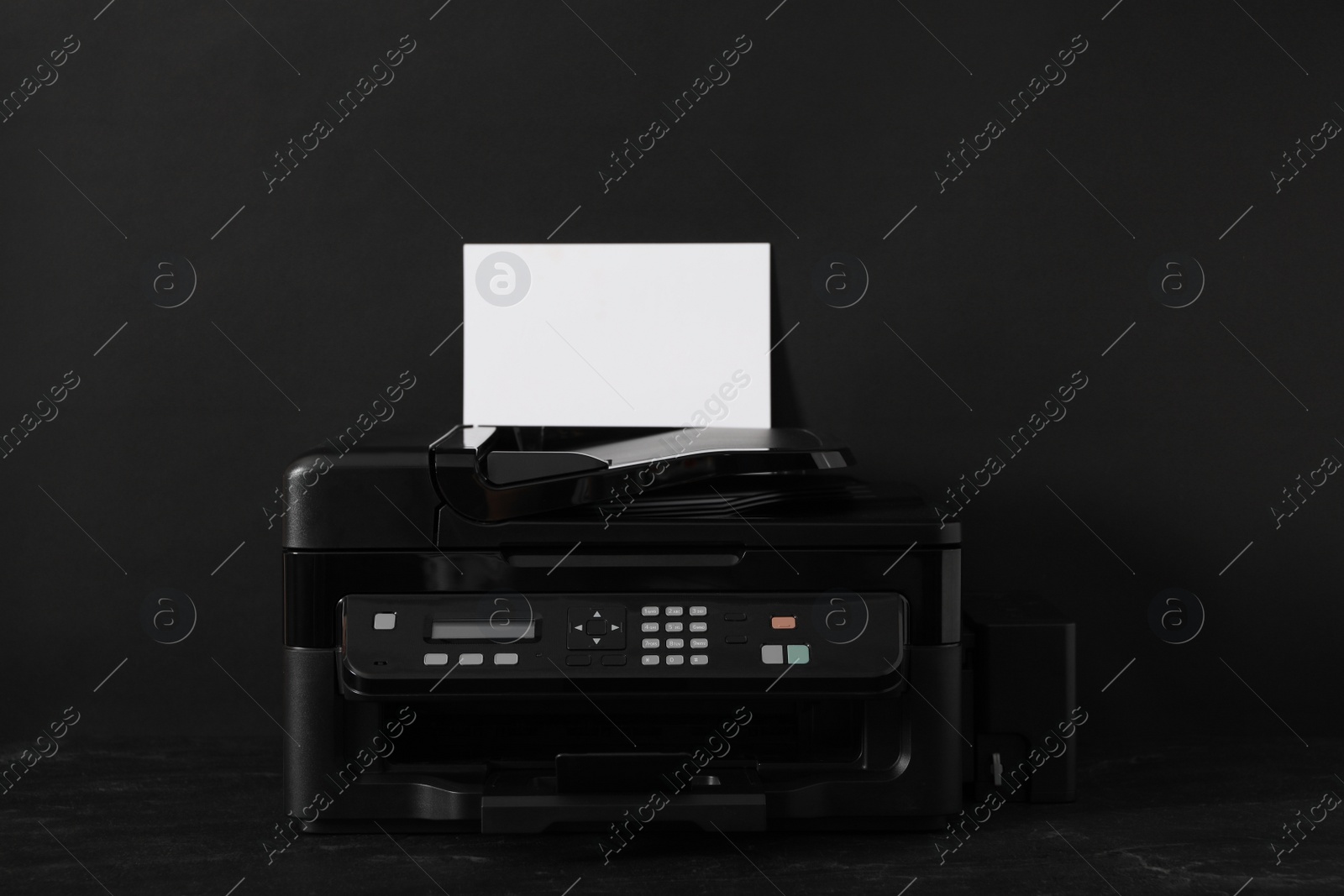 Photo of Modern printer with paper on black background