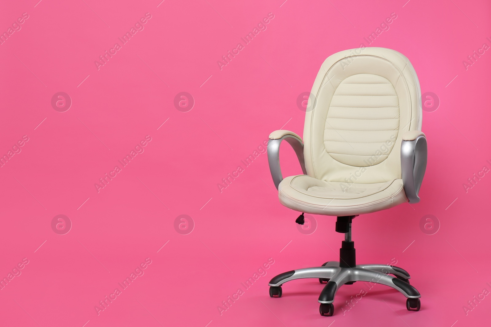 Photo of Comfortable office chair on pink background, space for text