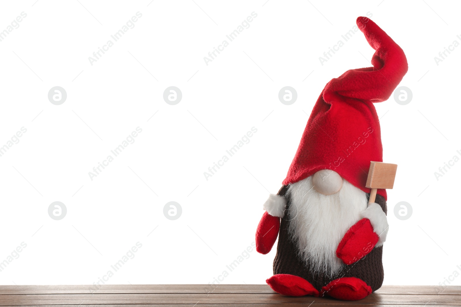 Photo of Funny Christmas gnome on wooden table against white background. Space for text