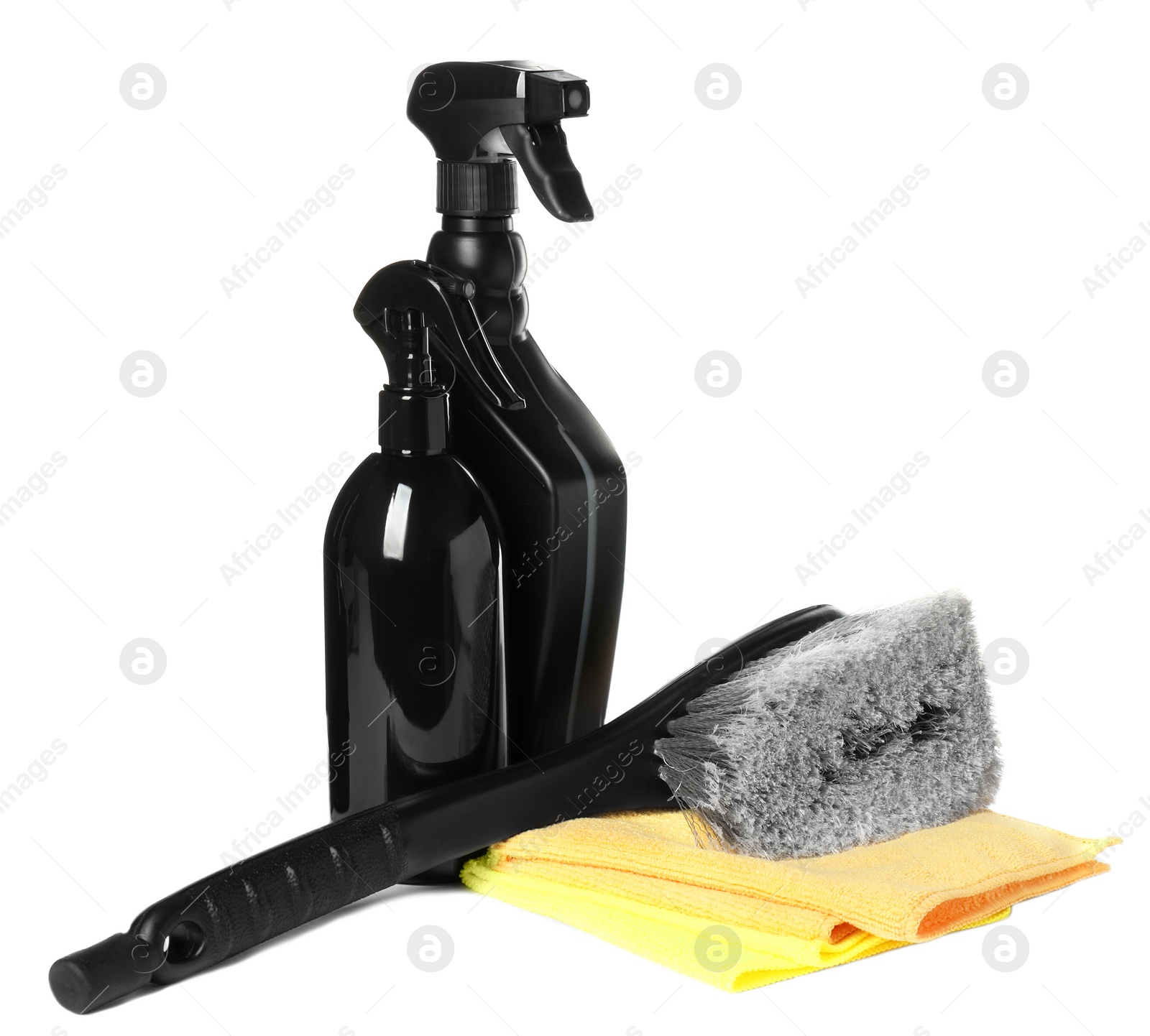 Photo of Spray bottles, brush and car wash cloths on white background