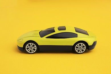 Photo of One bright car on yellow background. Children`s toy