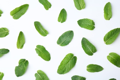 Flat lay composition with fresh green mint leaves on white background