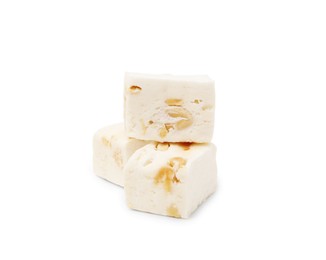 Photo of Pieces of delicious nougat on white background