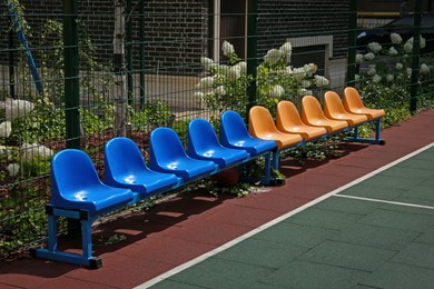 Photo of Empty chairs on outdoor children's playground in residential area