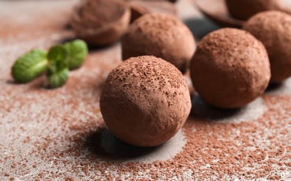 Photo of Delicious raw chocolate truffles on grey background