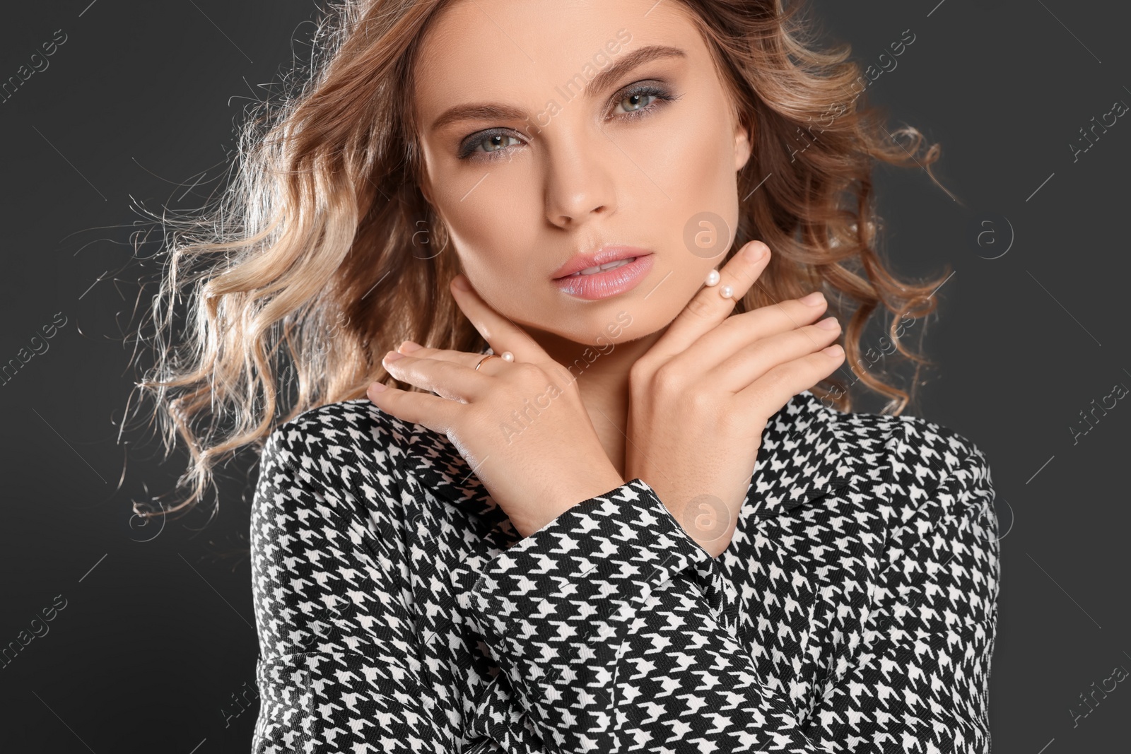 Photo of Portrait of young woman with beautiful makeup on black background