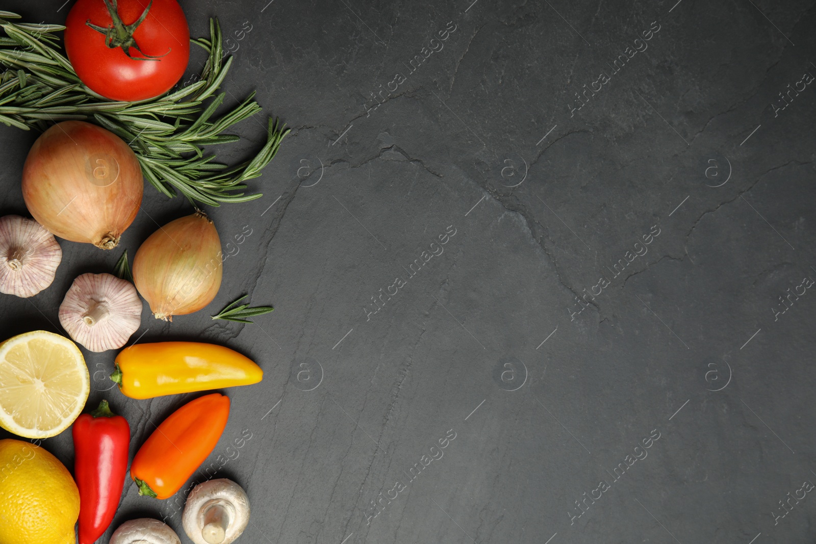 Photo of Flat lay composition with ingredients for cooking on black table. Space for text