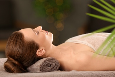 Photo of Beautiful young woman relaxing in spa salon