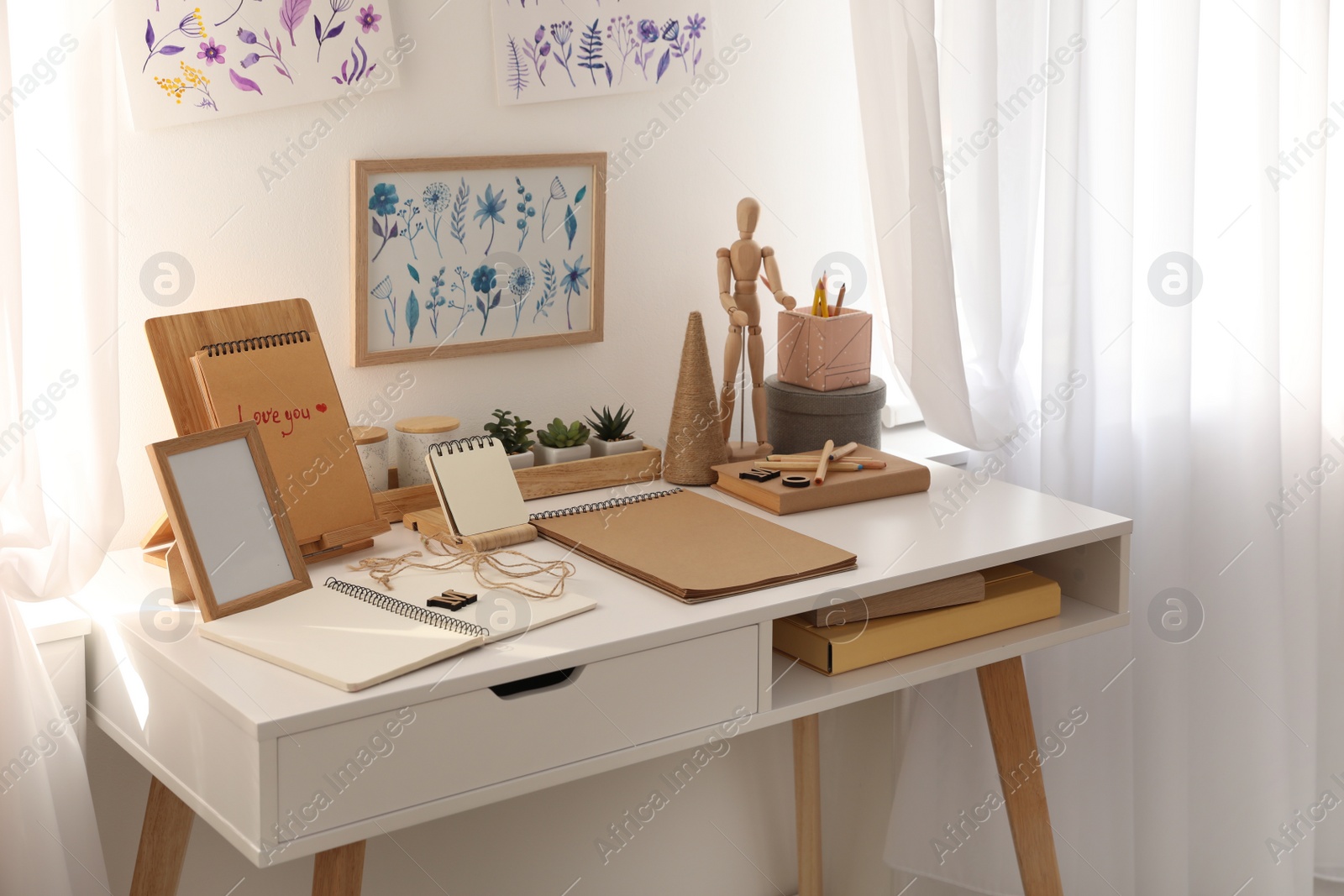 Photo of Stylish room interior with creative workplace near white wall