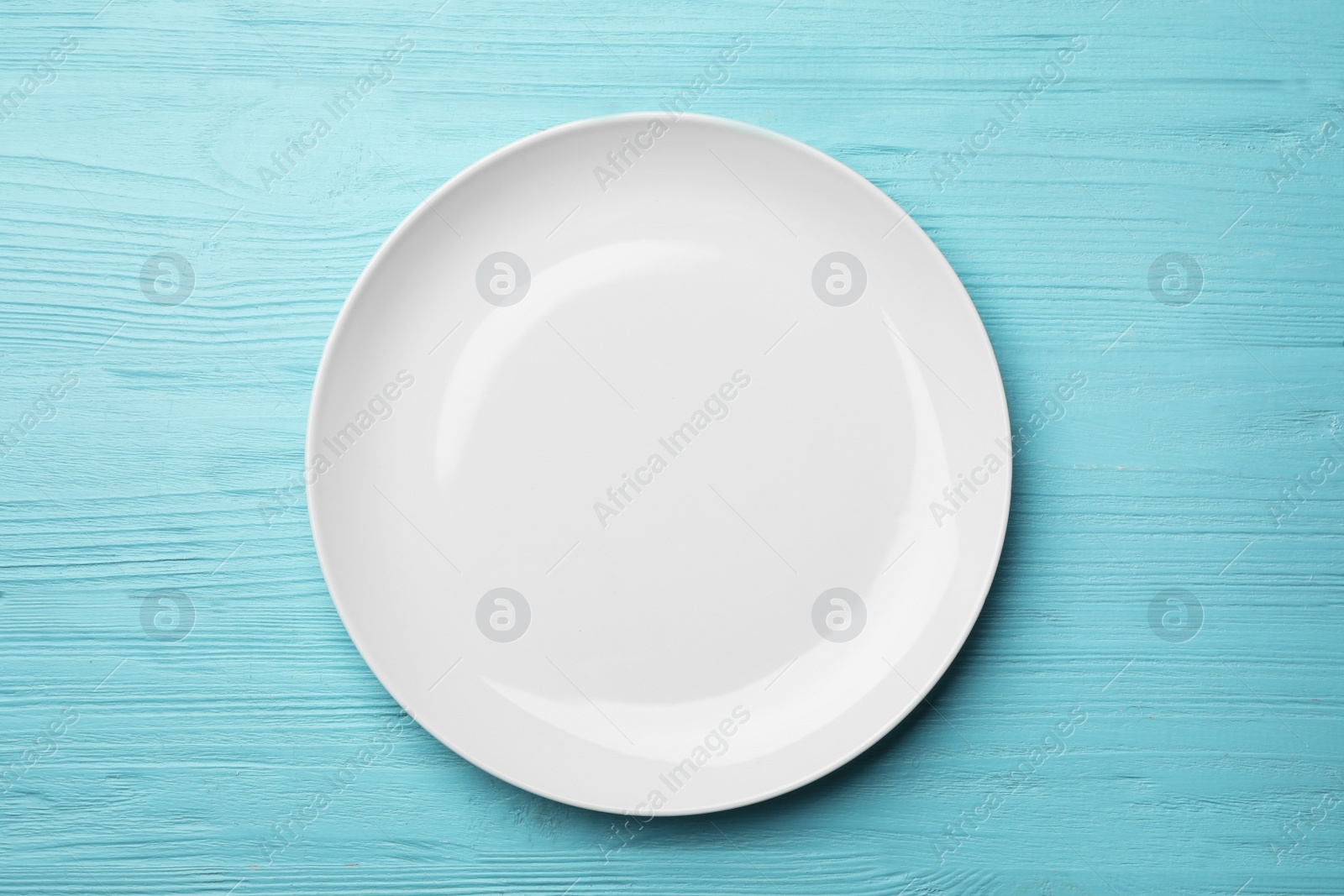 Photo of Stylish ceramic plate on wooden background, top view