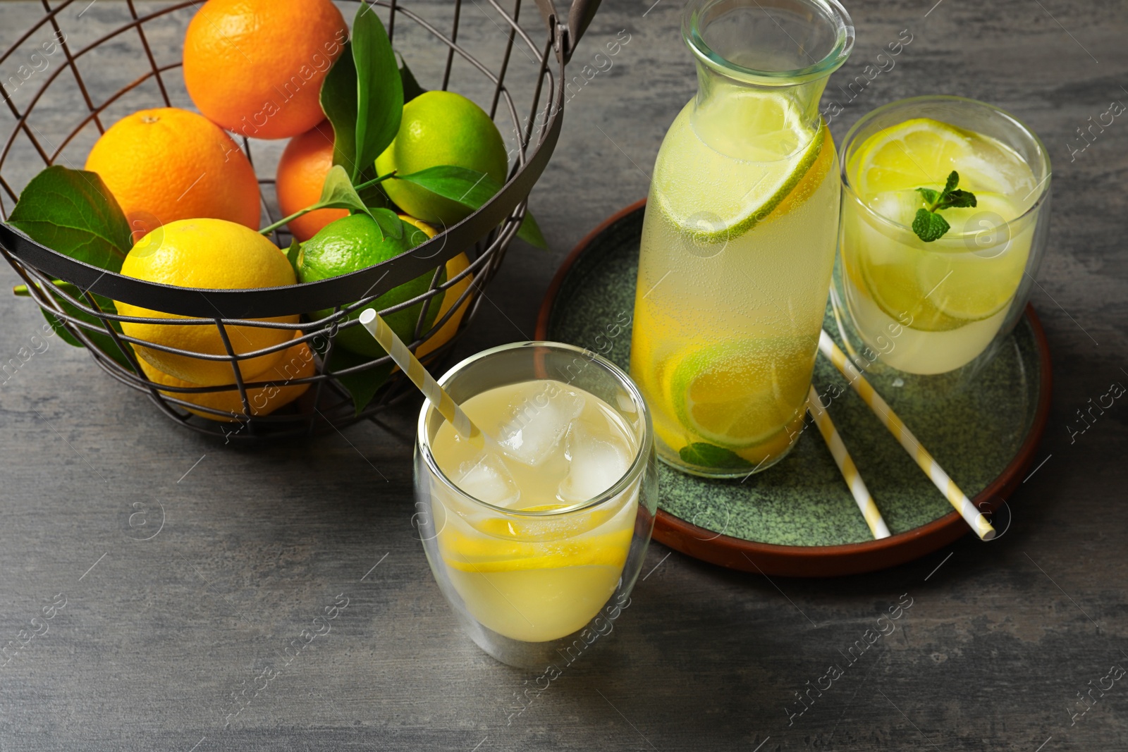 Photo of Composition with fresh lemonade on table