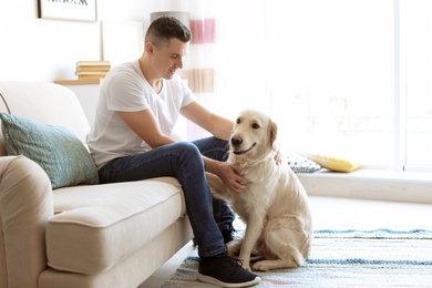 Portrait of owner with his friendly dog at home