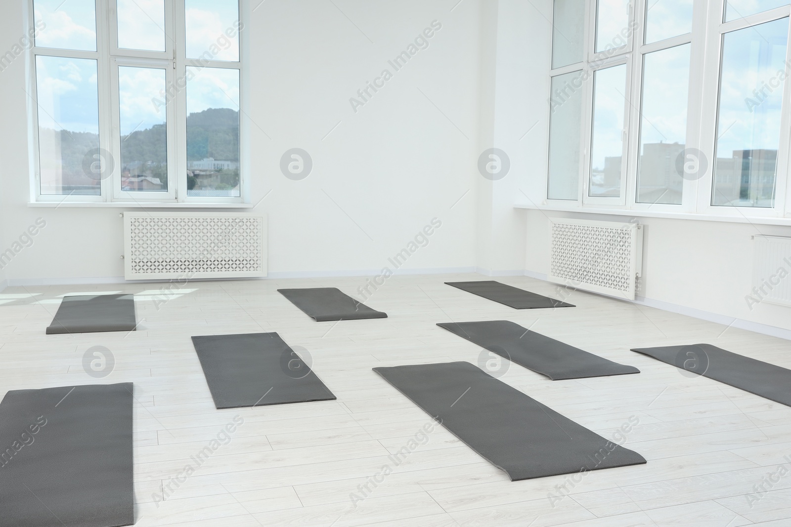 Photo of Spacious yoga studio with exercise mats and big windows