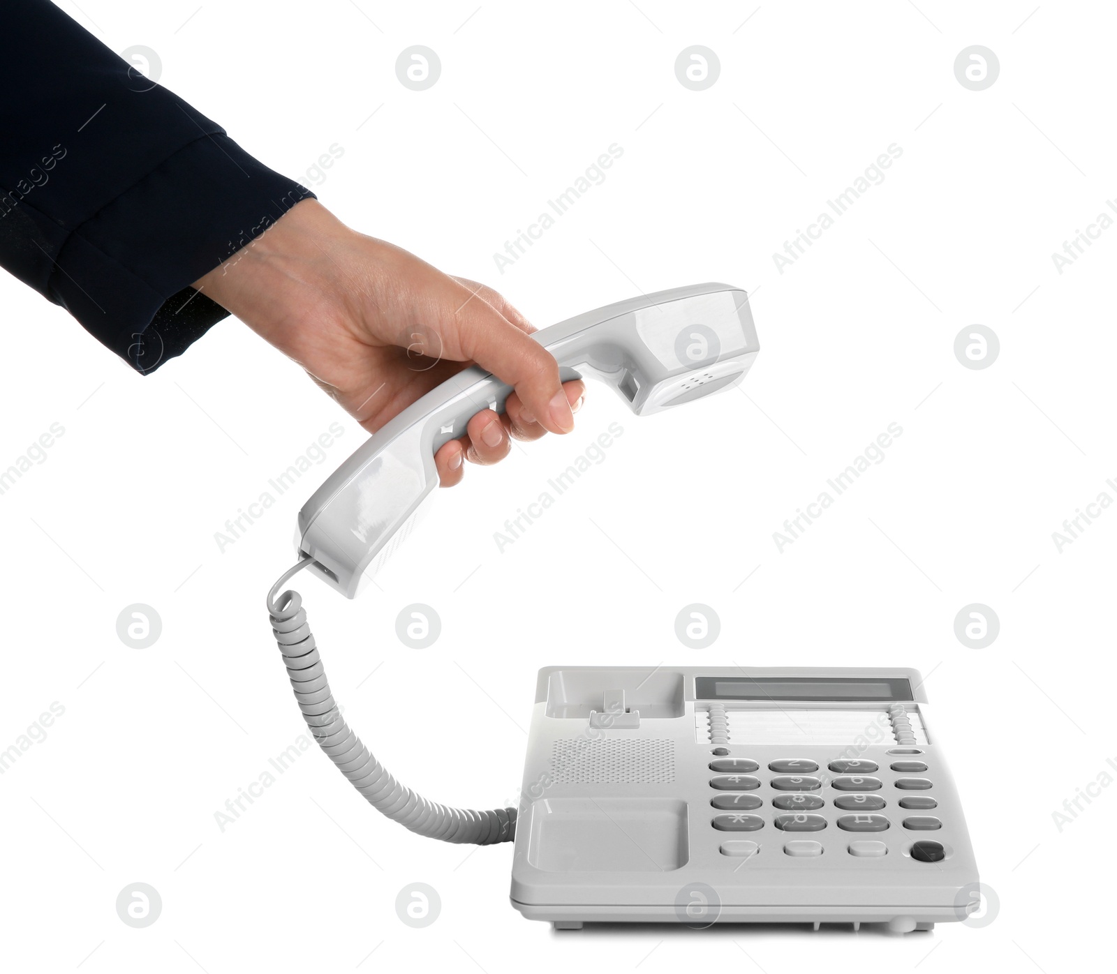 Photo of Young woman picking up telephone on white background