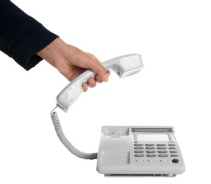 Photo of Young woman picking up telephone on white background