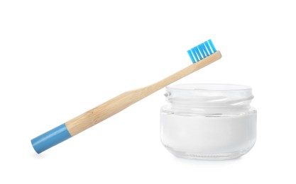 Bamboo toothbrush and bowl with baking soda on white background