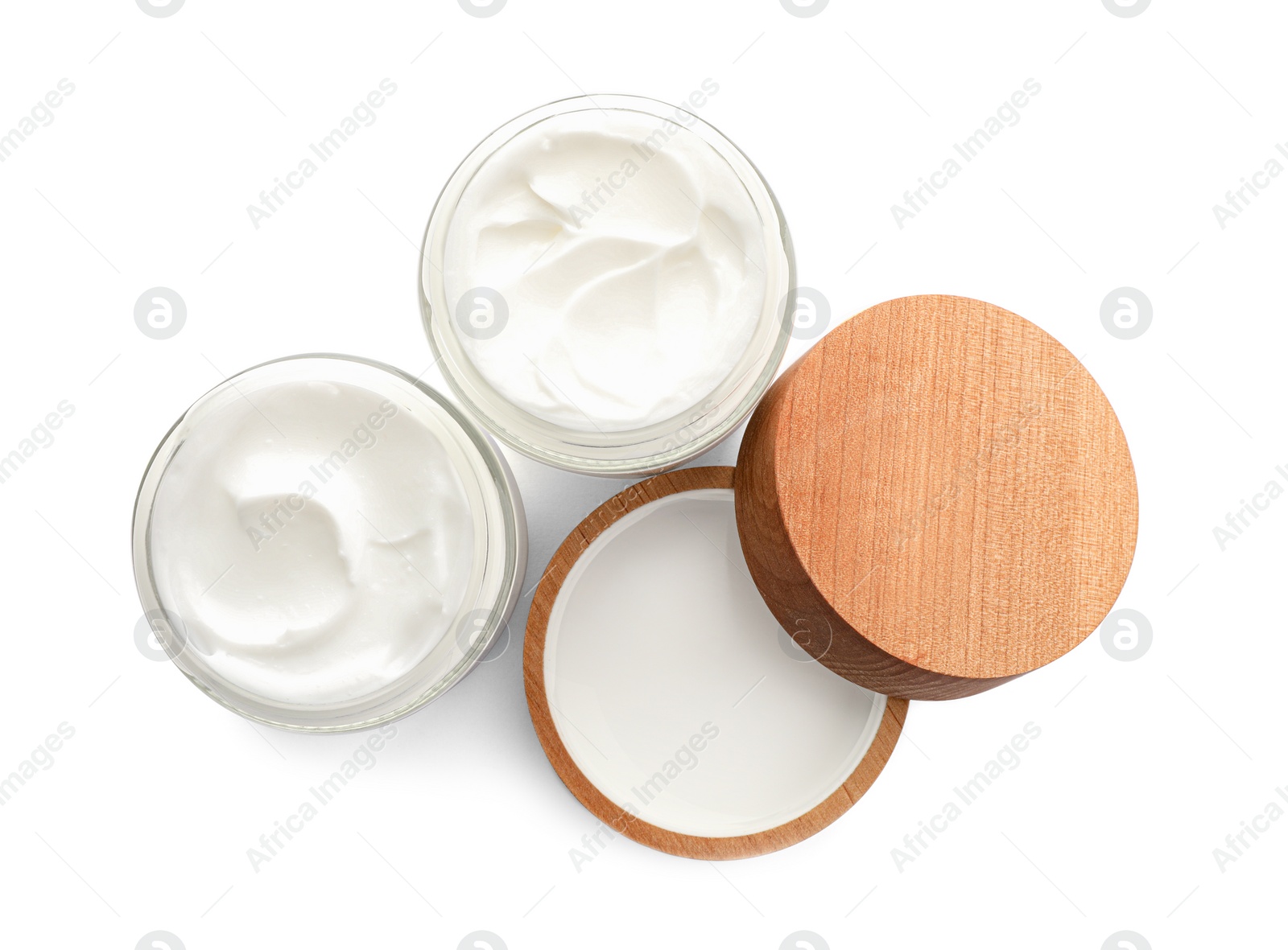 Photo of Jars of face cream isolated on white, top view