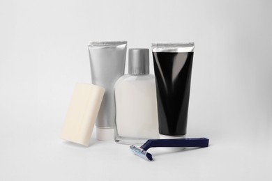 Different men's shaving accessories on light background