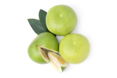 Photo of Whole and cut sweetie fruits with green leaves on white background, top view