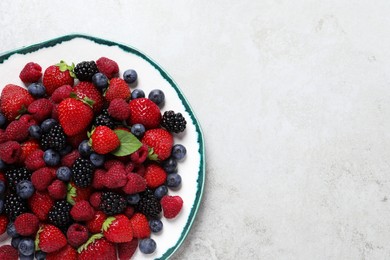 Different fresh ripe berries on light grey table, top view. Space for text