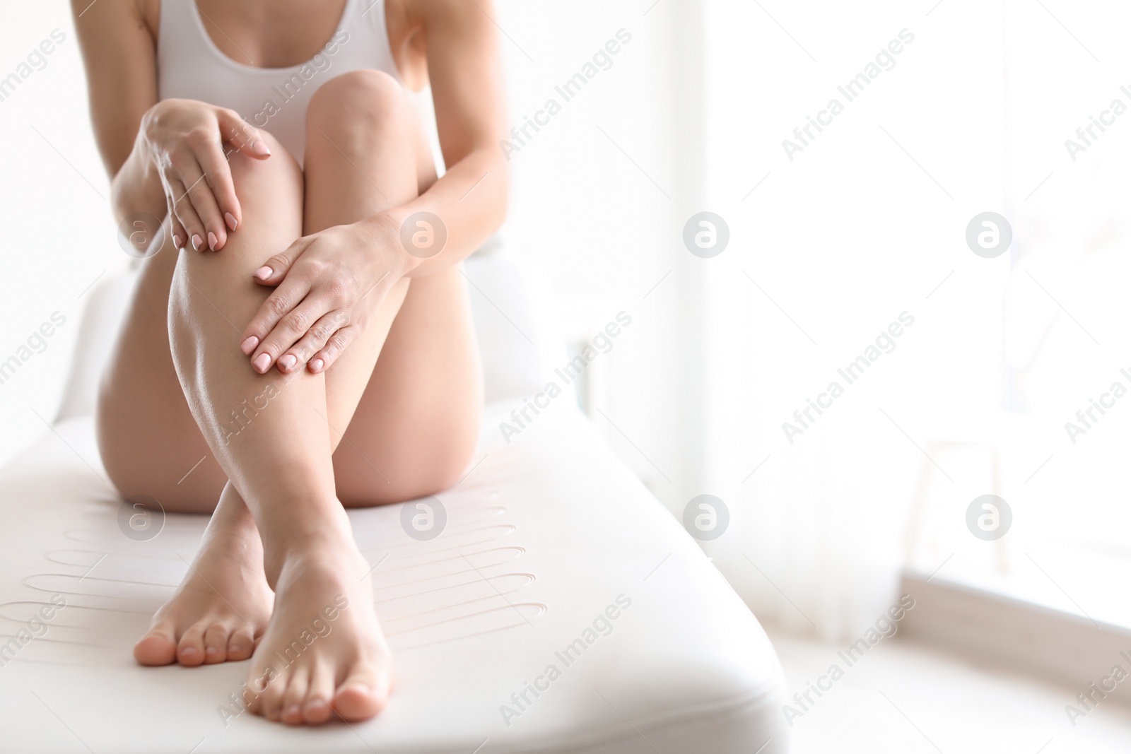 Photo of Young woman showing smooth silky skin after epilation at home