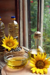 Photo of Organic sunflower oil and flowers on window sill indoors