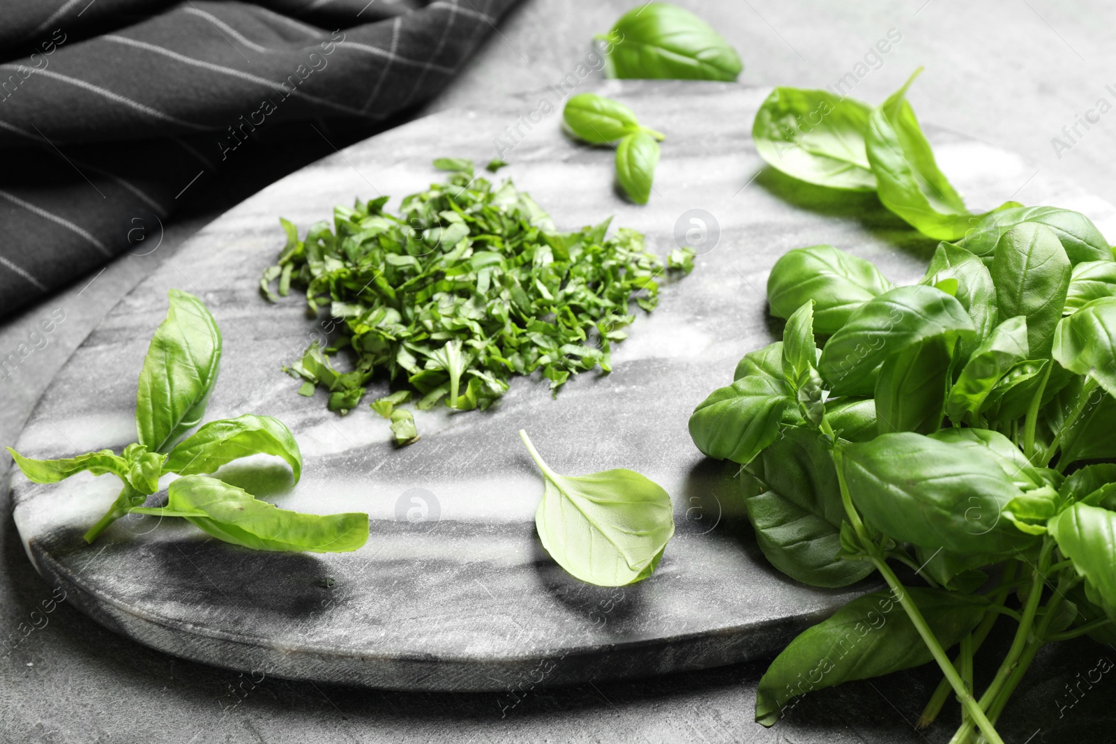 Photo of Fresh green basil on light grey table