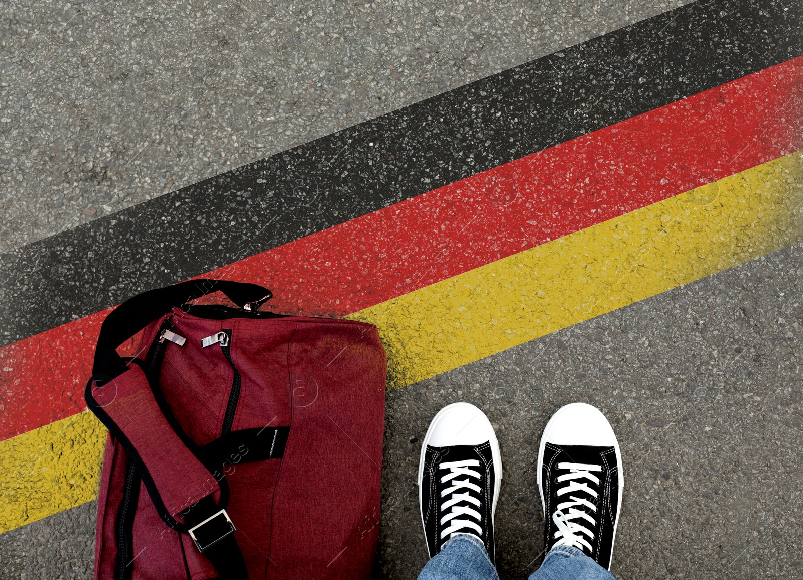 Image of Immigration. Man with bag standing on asphalt near flag of Germany, top view