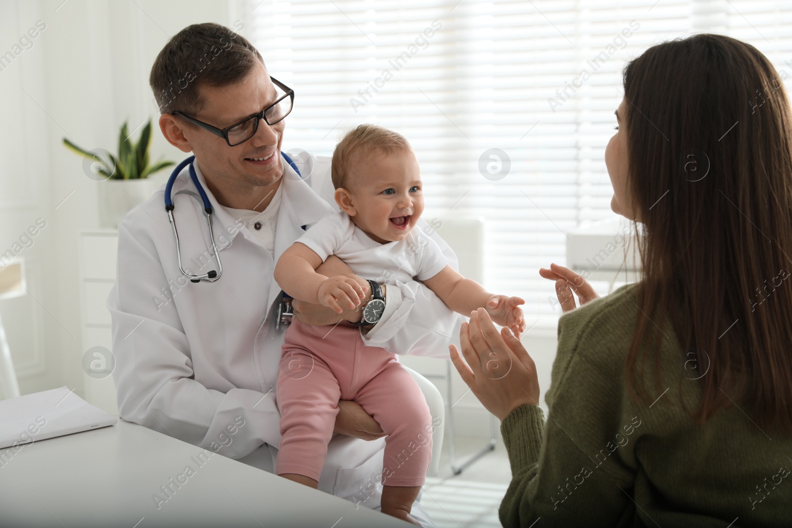 Photo of Mother with her cute baby visiting pediatrician in clinic