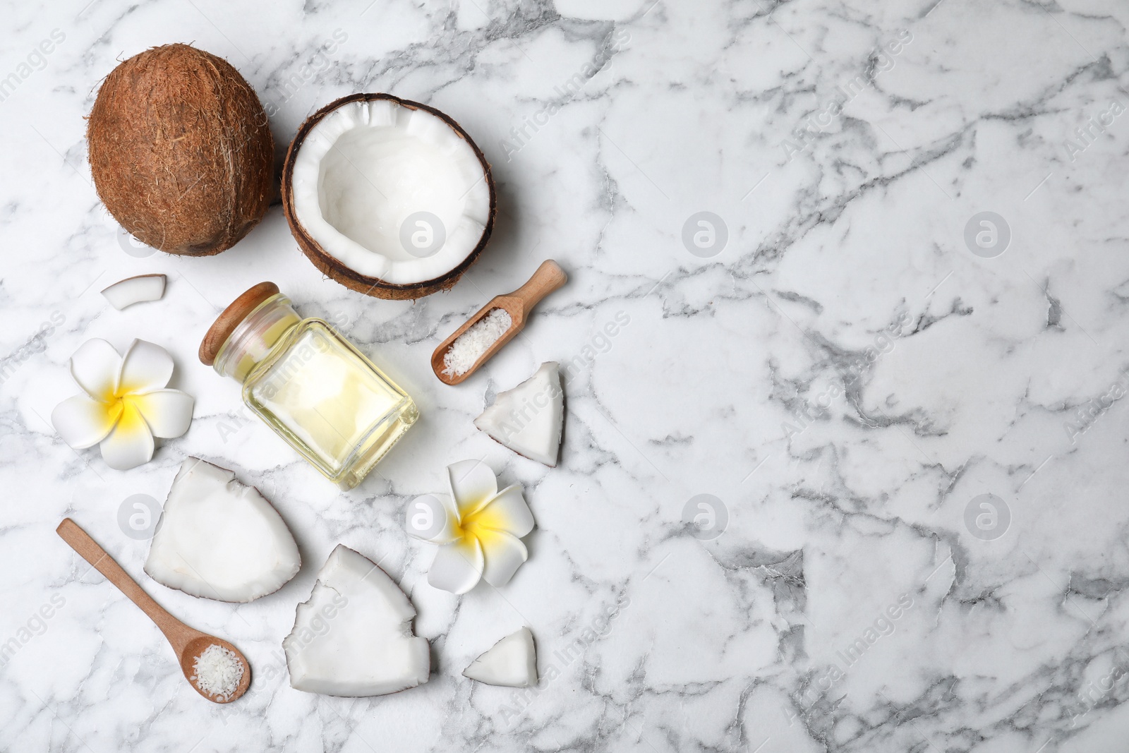 Photo of Flat lay composition with natural organic coconut oil on marble background. Space for text