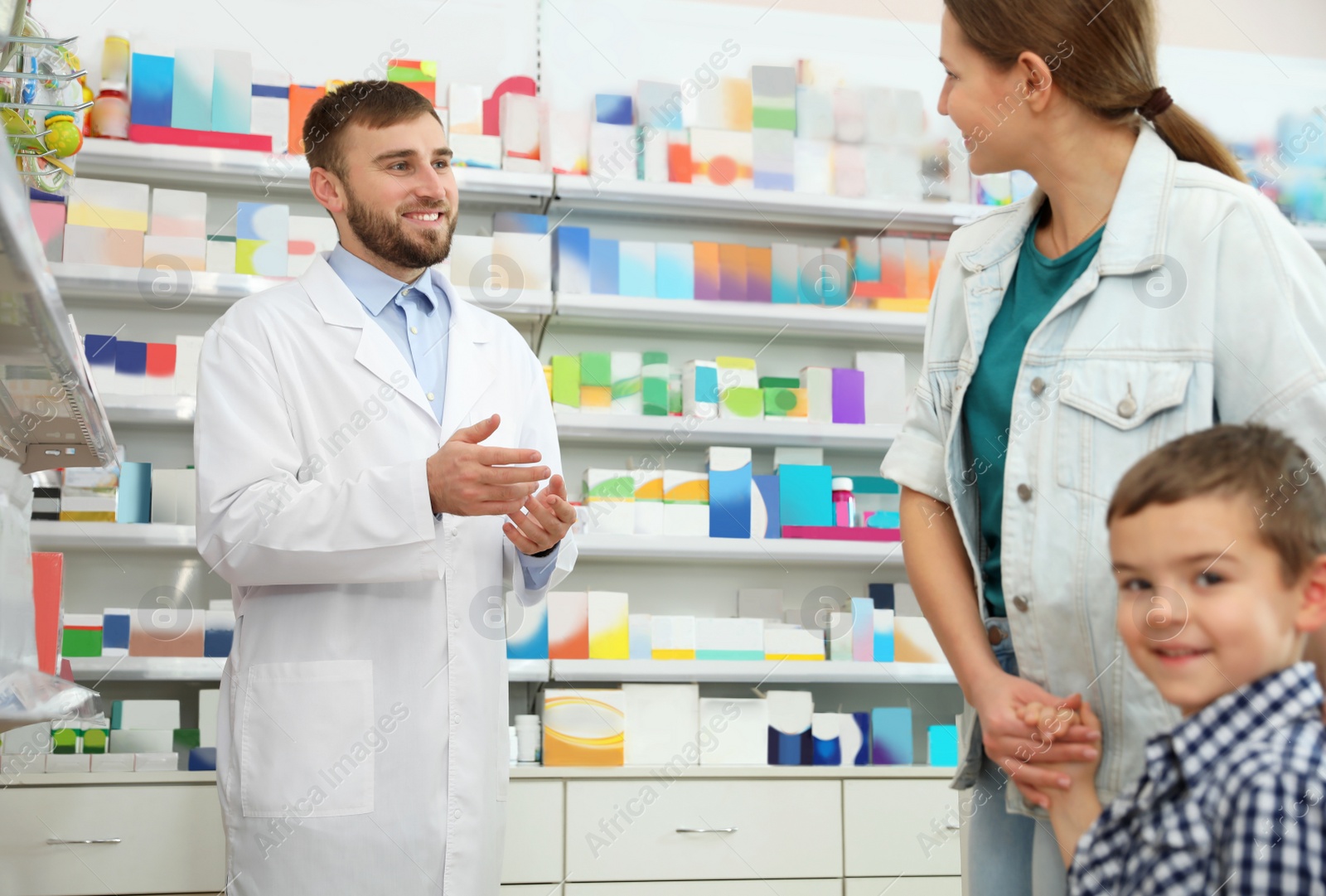 Image of Professional pharmacist working with customer in modern drugstore