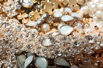 Different stylish jewelry as background, closeup view