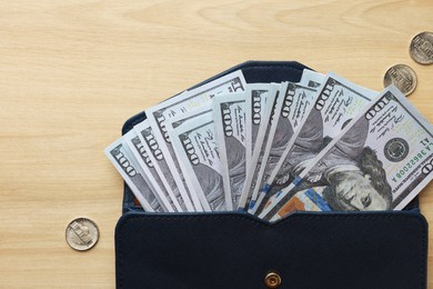 Photo of Dollar banknotes, coins and wallet on wooden table, flat lay with space for text. Money exchange