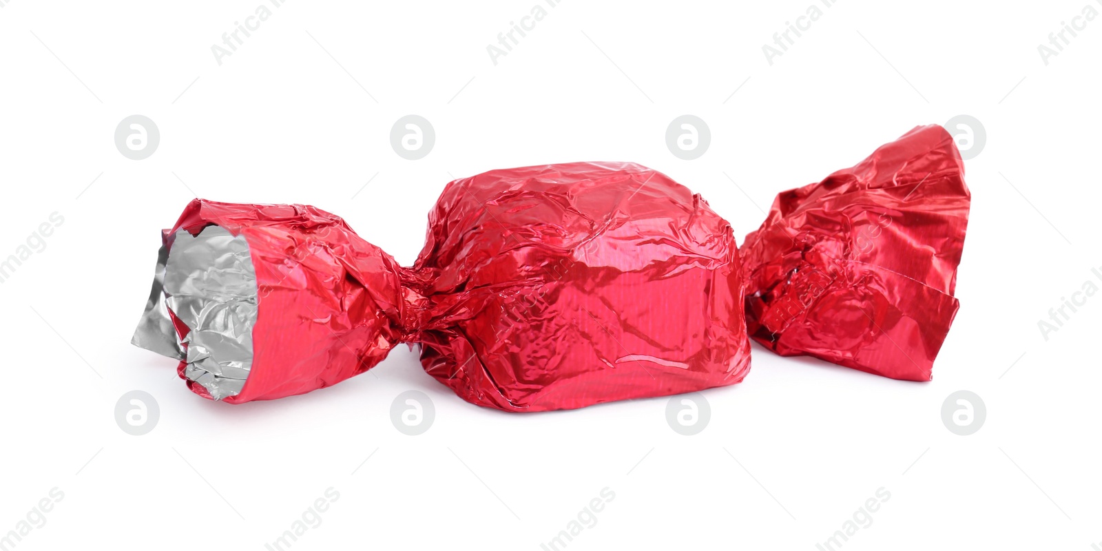 Photo of Tasty candy in red wrapper isolated on white