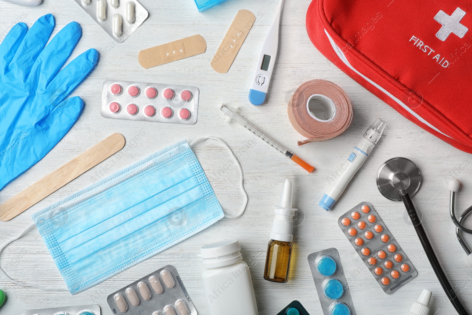 Photo of Flat lay composition with first aid kit on wooden background