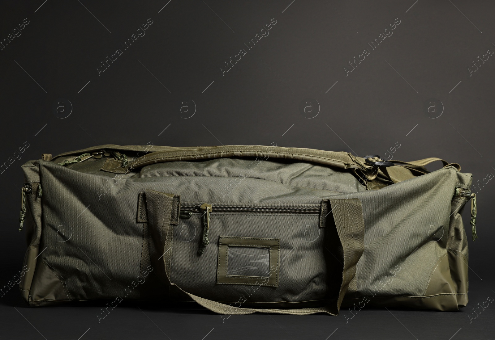 Photo of Army bag on dark grey background. Military equipment