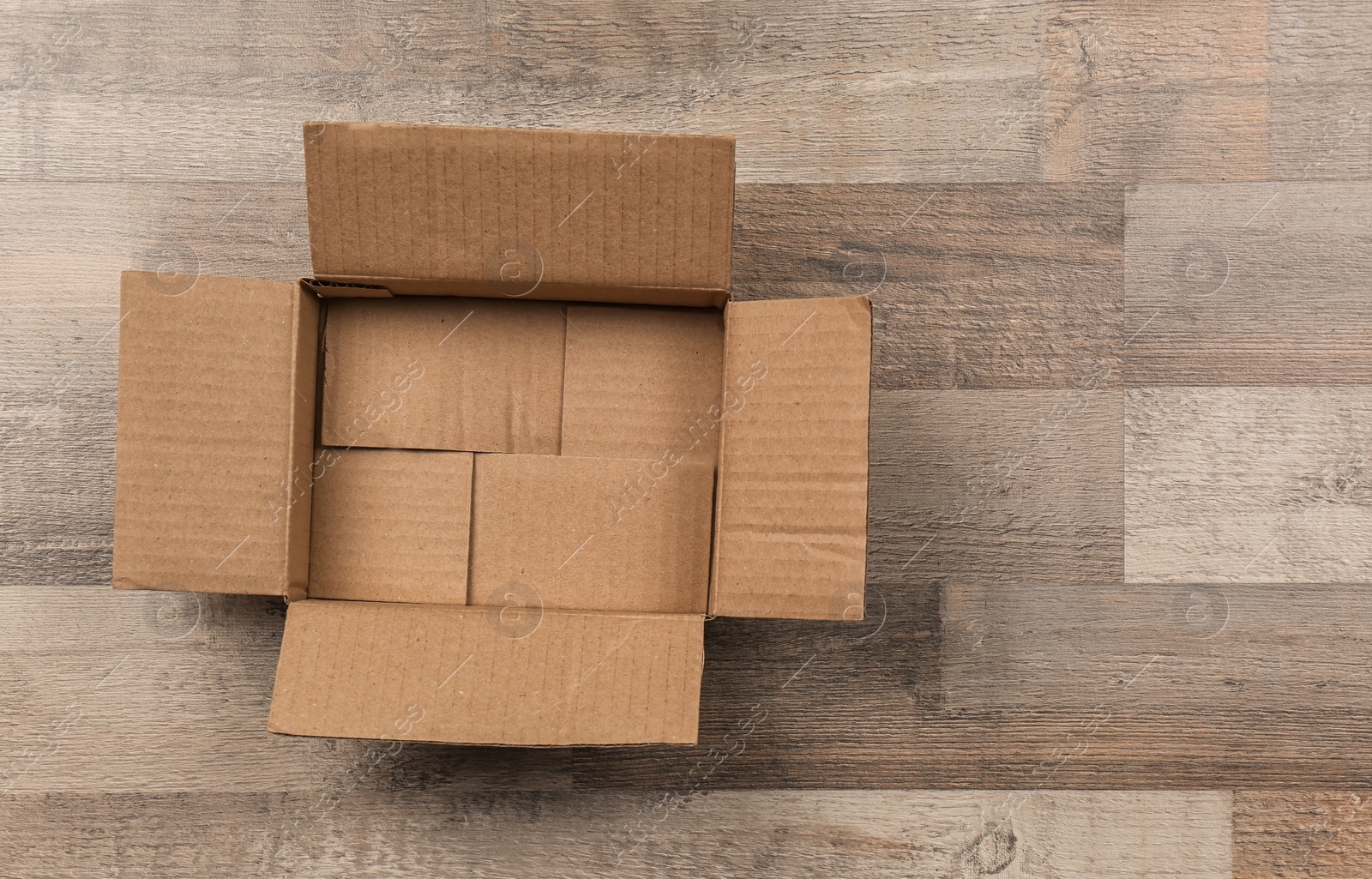 Photo of Cardboard box on wooden floor